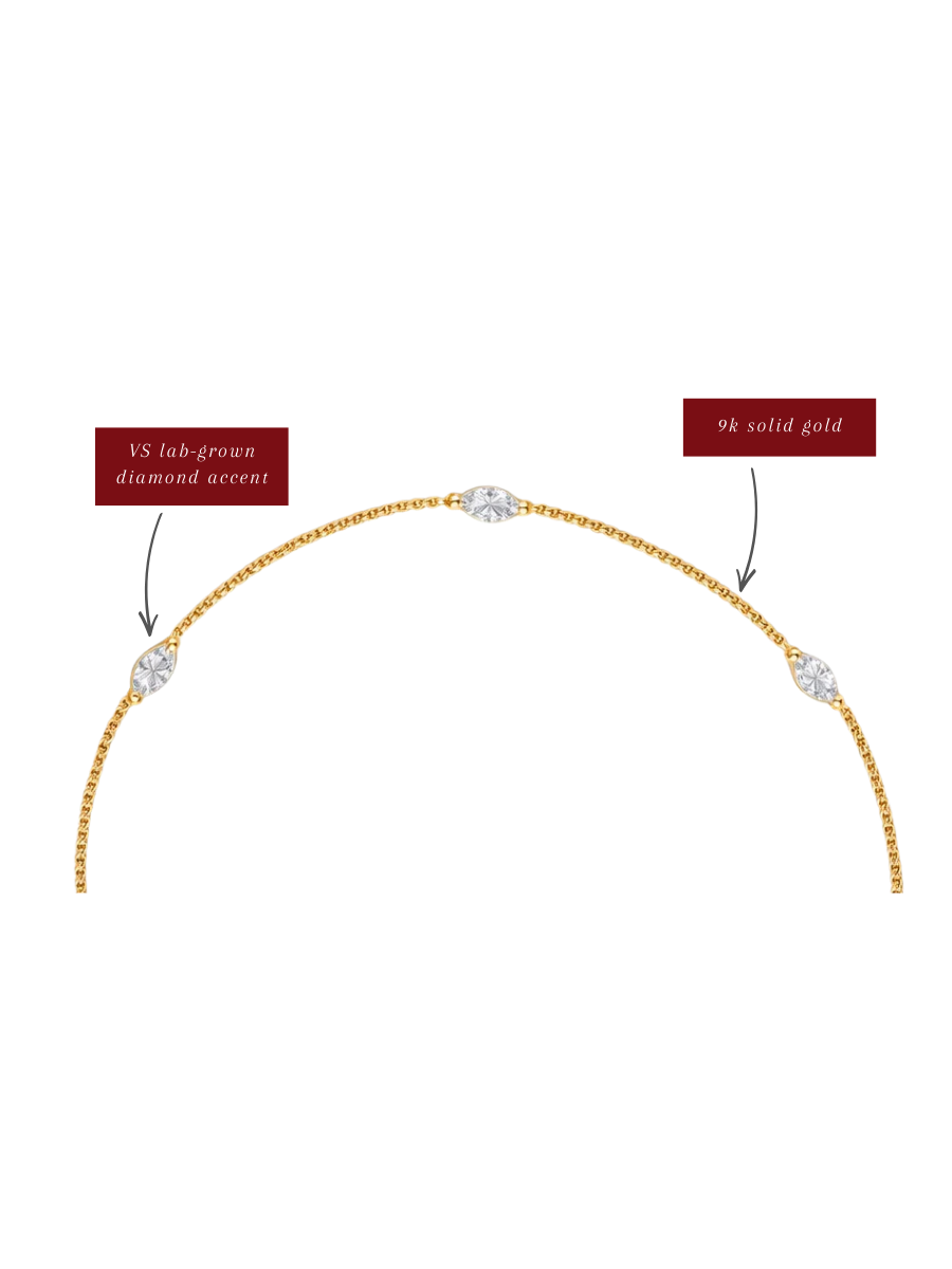 Gold necklace with diamond accents on a white background